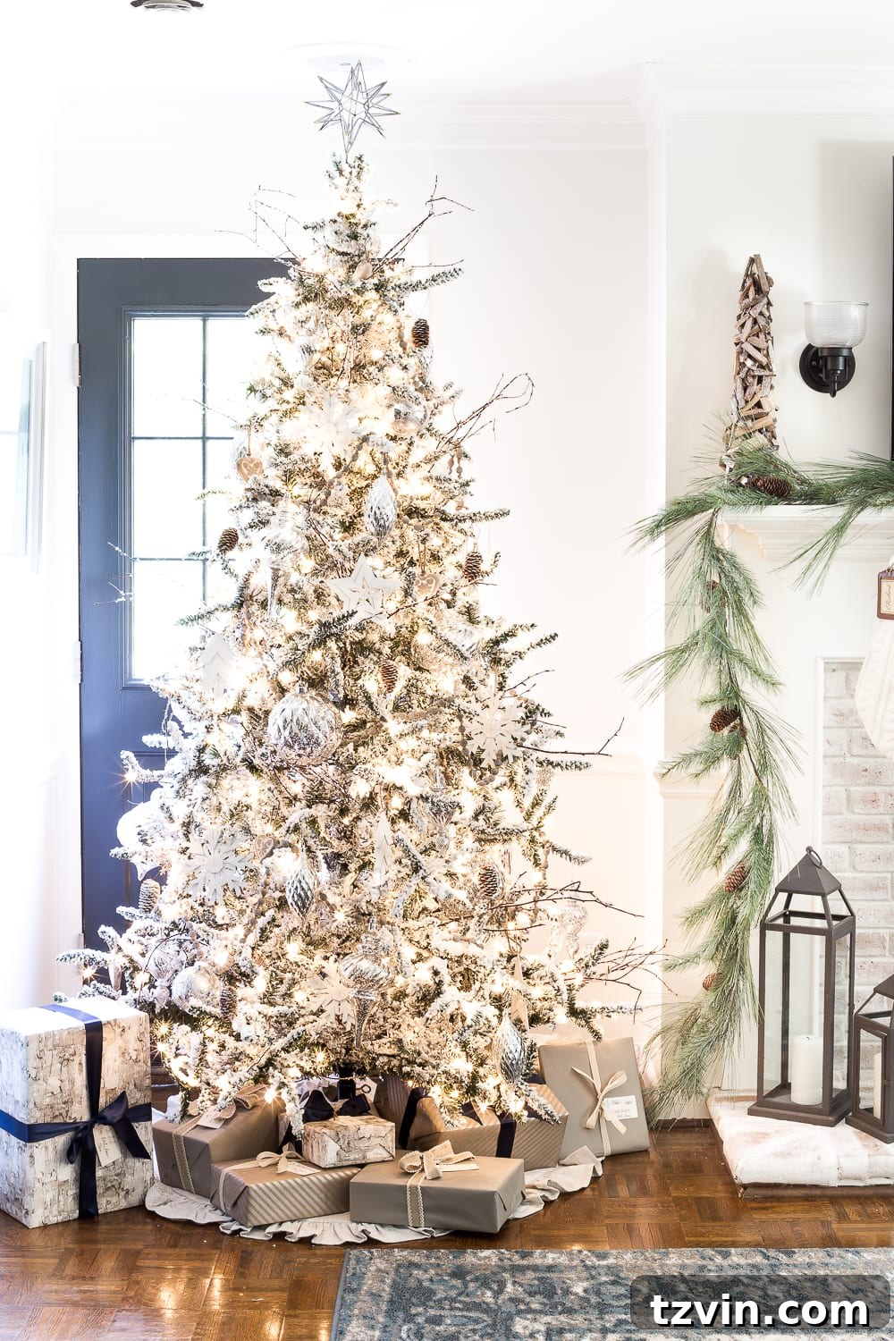 Christmas decor on a side table with a mercury glass lamp, adding a touch of vintage charm to the neutral holiday theme.