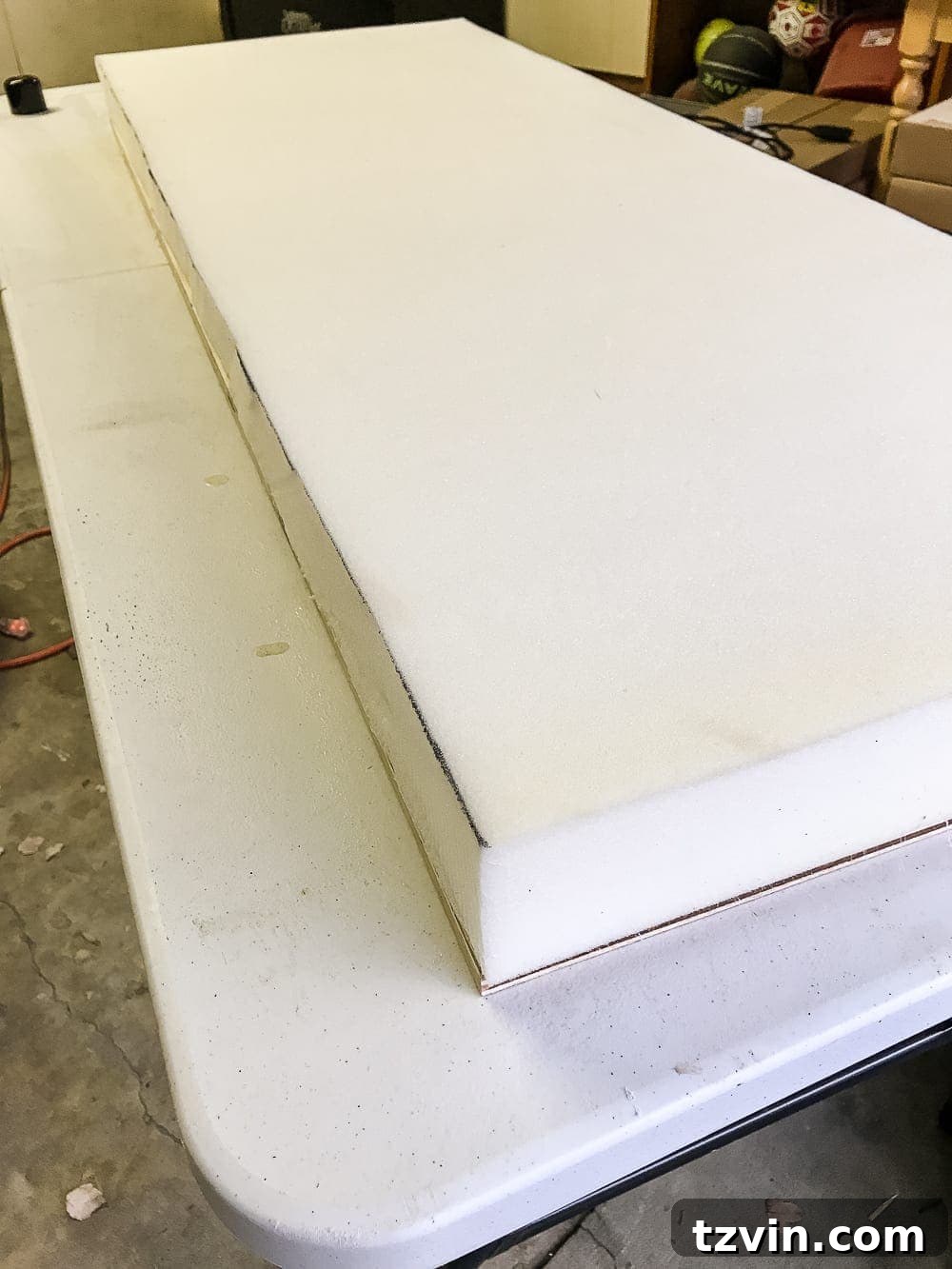 Applying spray adhesive to foam and plywood