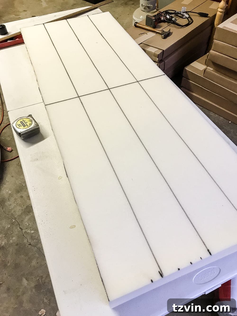 Carefully aligning and pressing foam onto plywood base