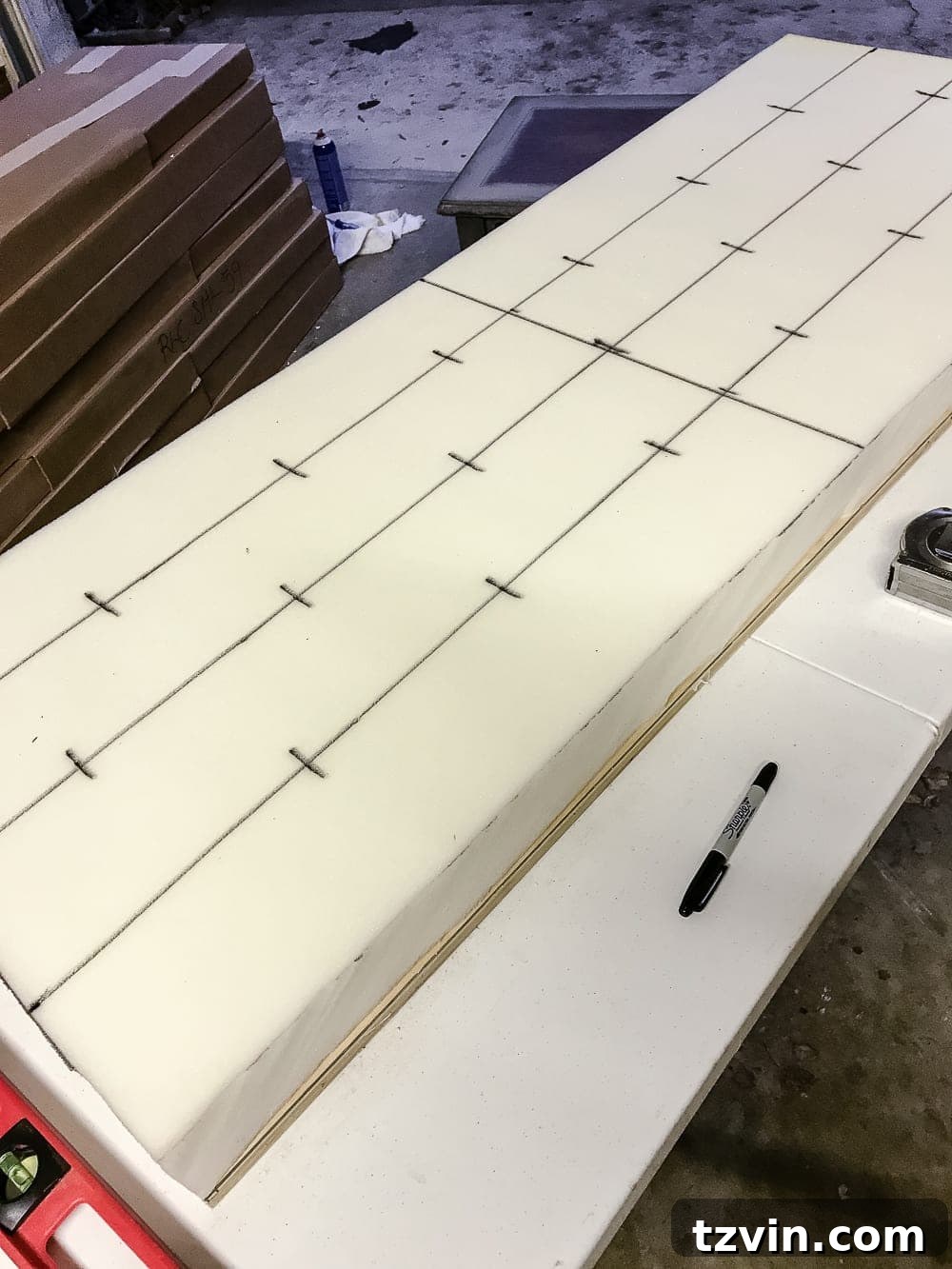 Marking the foam with a grid for tufting button placement