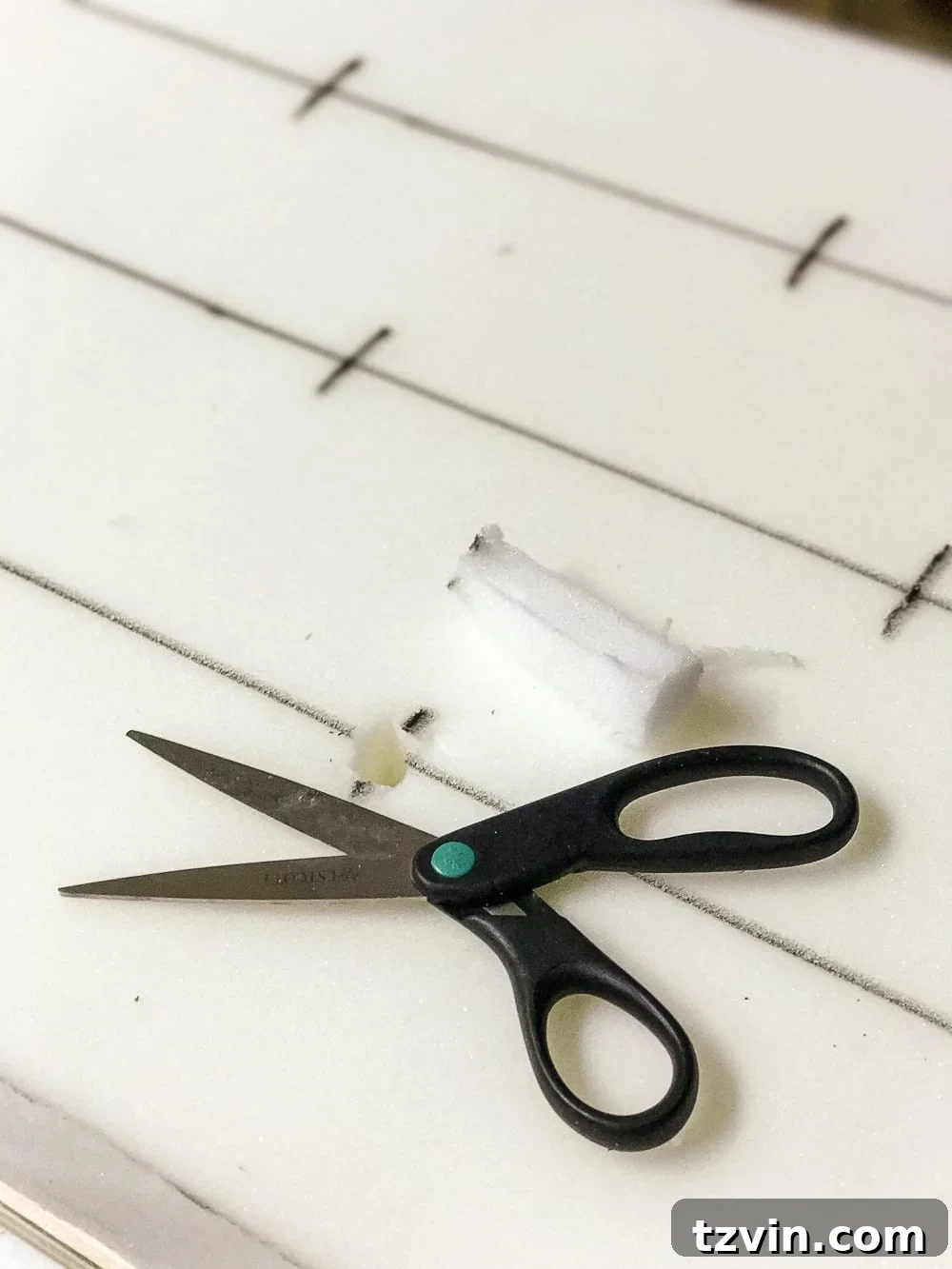 Cutting one-inch lines in foam for tufting buttons