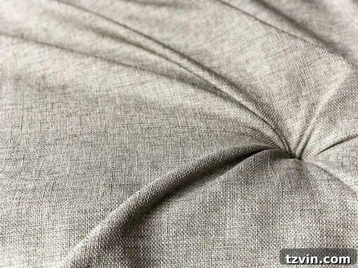 Beginning the tufting process by pushing fabric into the first hole