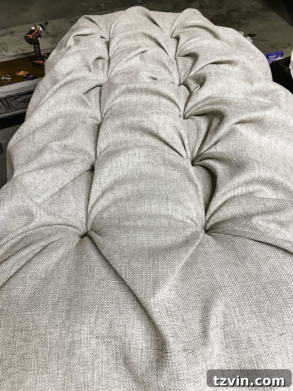 Progress of tufting, securing outer rows with screws and washers