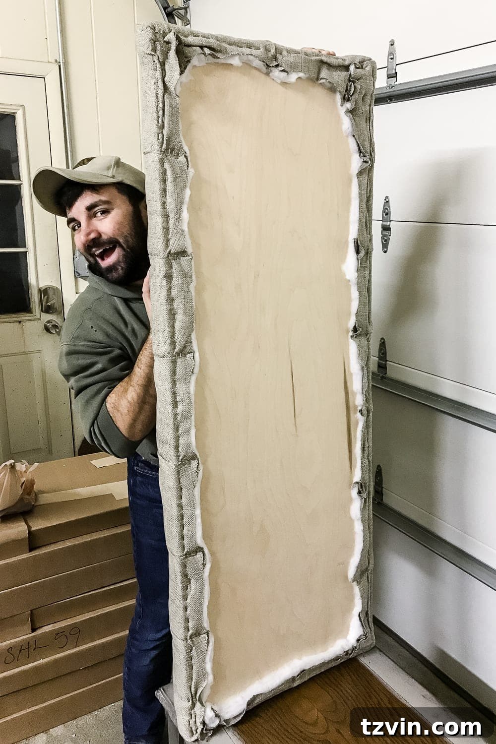 Stapling fabric edges to the back of the plywood base