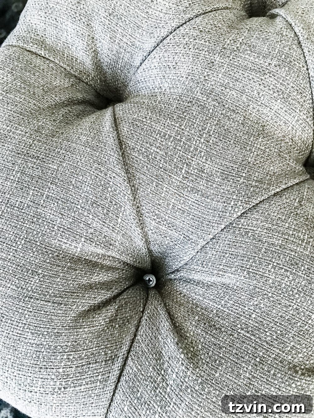 Trimming excess fabric and batting from the ottoman underside
