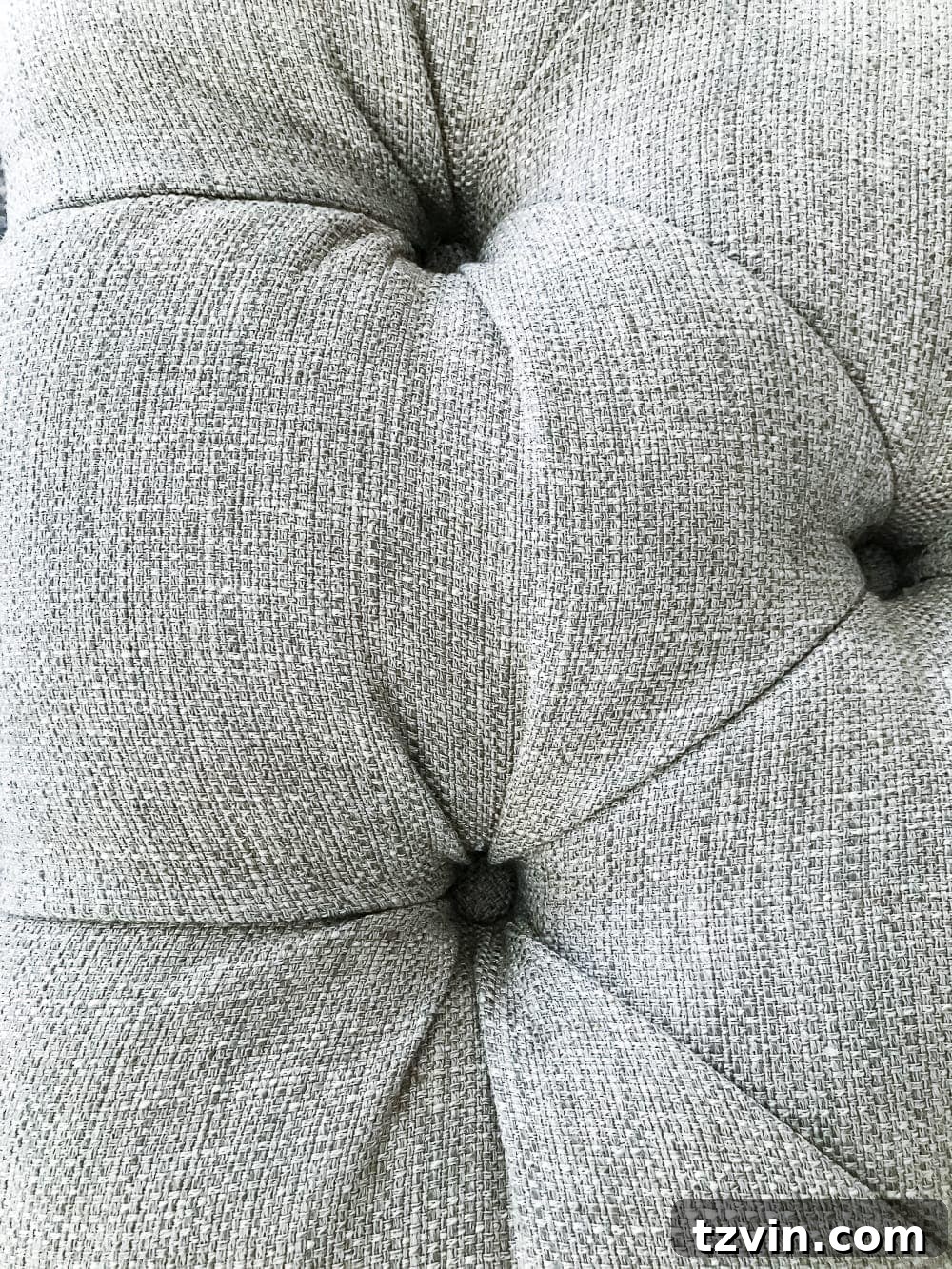 Hot gluing custom fabric buttons onto tufted screws
