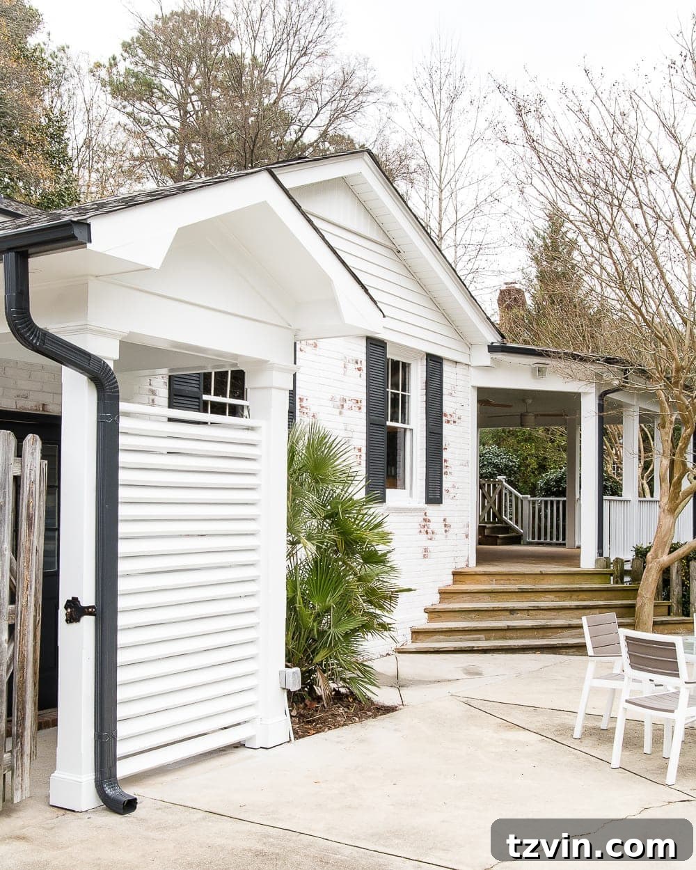 back house exterior with white brick and black shutters