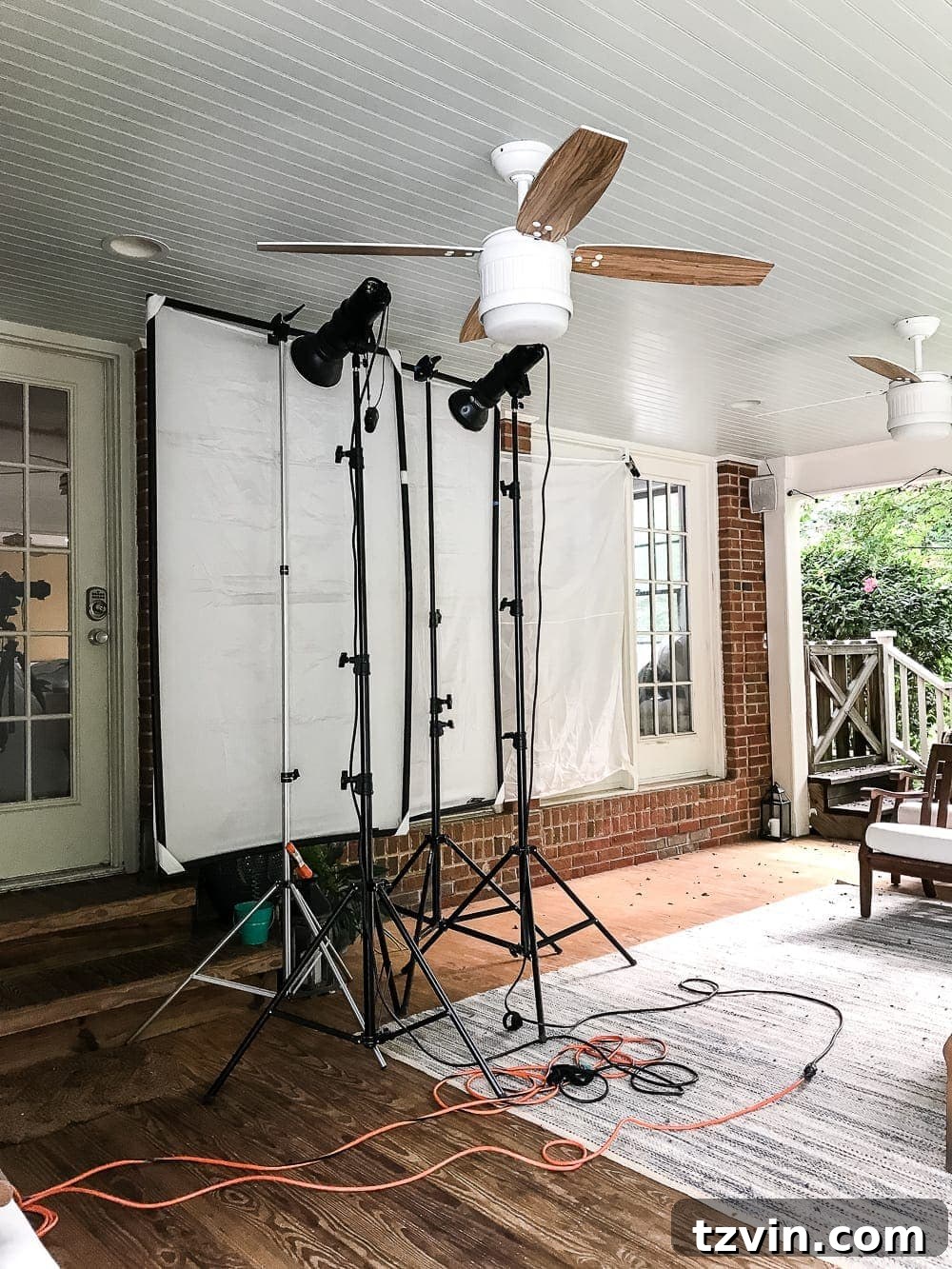Behind the Scenes with Better Homes and Gardens 3 Behind the scenes of a Better Homes and Gardens magazine photoshoot, showing the extensive lighting and white screen setup on a back porch for interior shots. #betterhomesandgardens #photoshootbts #homedecor #interiorphotography