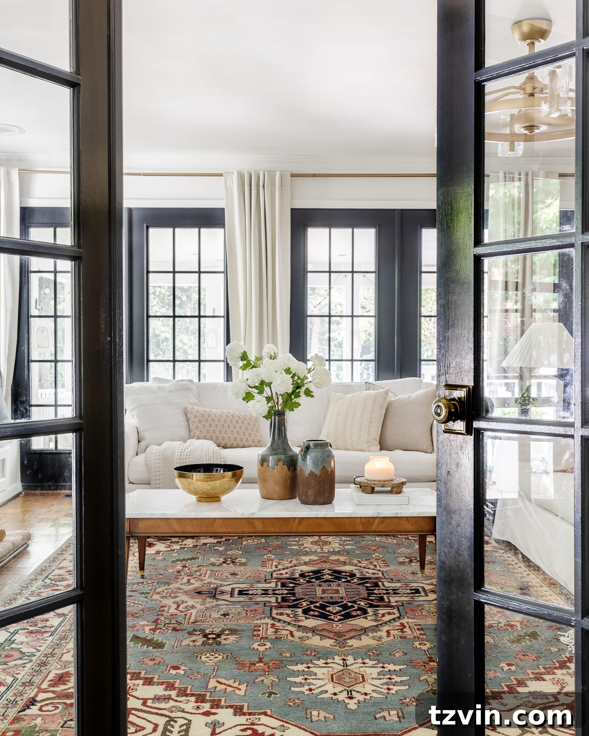 A wall of beautifully painted black French doors in a modern living room