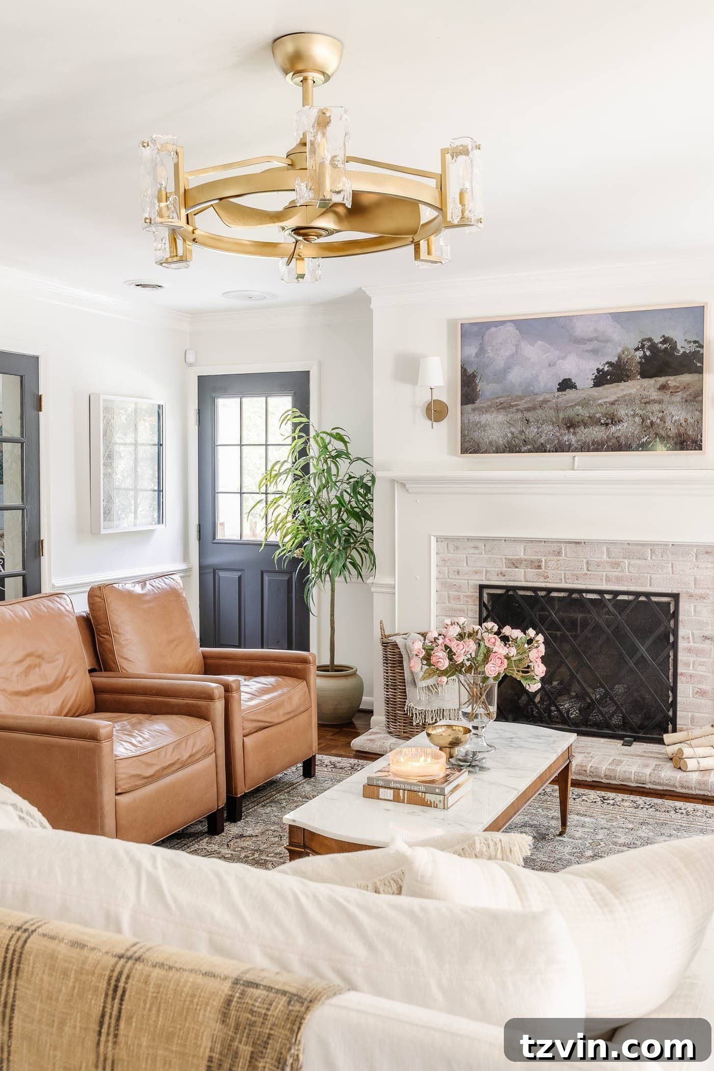 old door in a living room featuring leather recliners, lime washed brick fireplace, and a fandelier