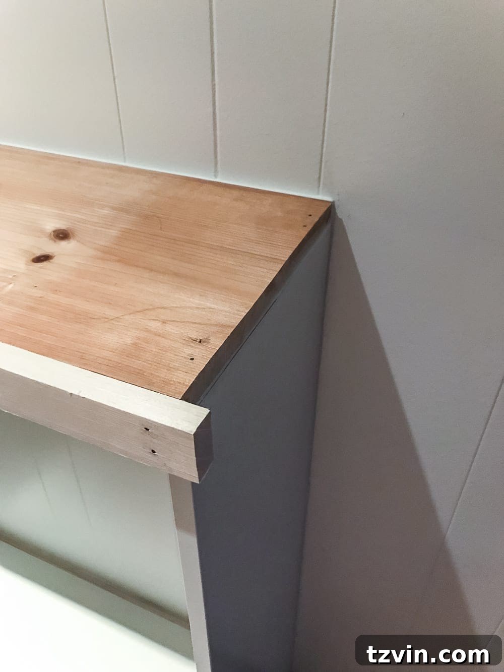 Custom Playroom Library Corner 14 Detail shot of the front 1x2 trim board attached to the custom wood top of the IKEA Billy built-ins.