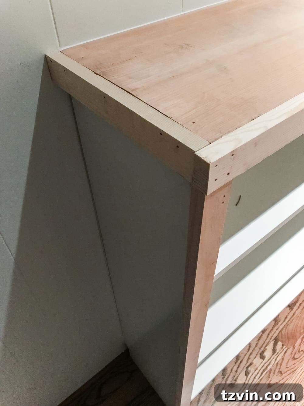 Custom Playroom Library Corner 15 Completing the custom wood top by adding side 1x2 boards to the IKEA Billy built-ins.