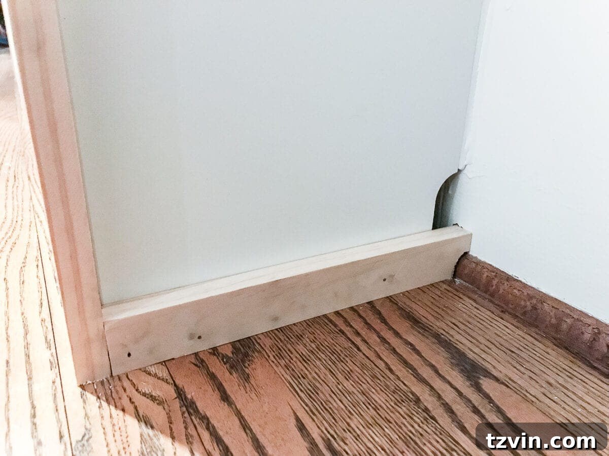Custom Playroom Library Corner 17 Showing how caulk can fill small gaps and imperfections on DIY IKEA Billy built-ins.