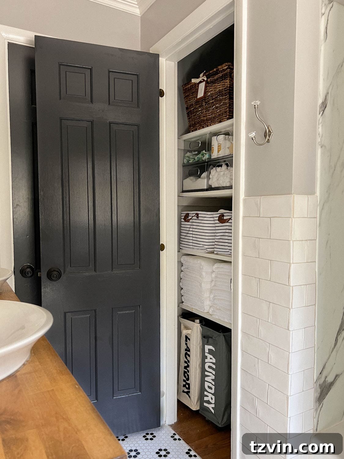 Flawless Bathroom Linen Closet Organization Ideas 14 linen closet in a bathroom with black door, white tile, and gray walls