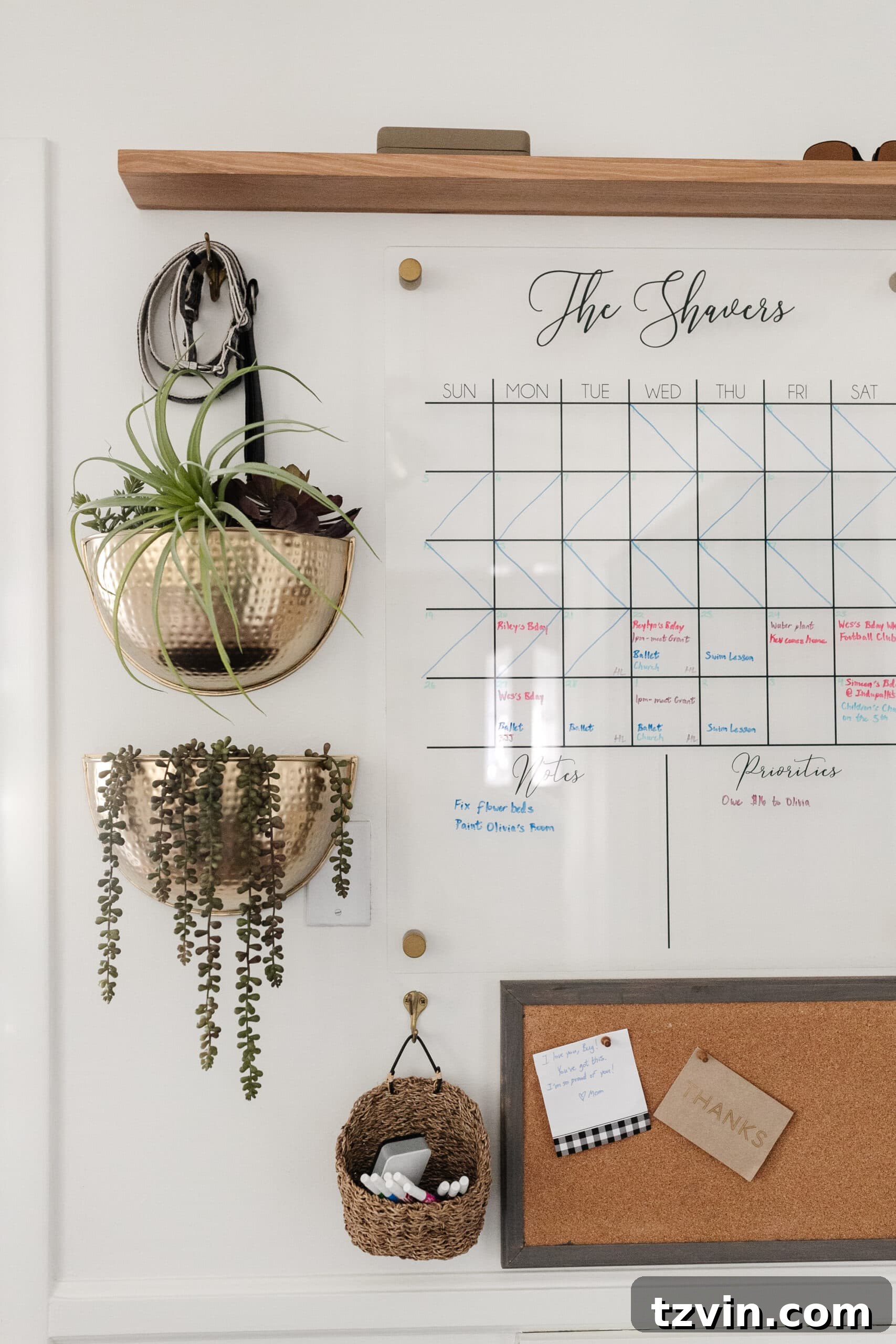 Organizing Your Family: Command Center Essentials 10 family command center with wall calendar, brass planters, shelf, and memo board