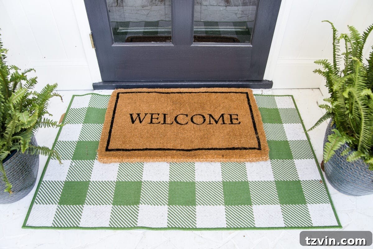 Small Stoop, Big Style: 4 Simple Decorating Steps 4 4 easy steps to decorate a small porch stoop for spring to make any home more welcoming for guests. #springporch #smallporch #porchstoop