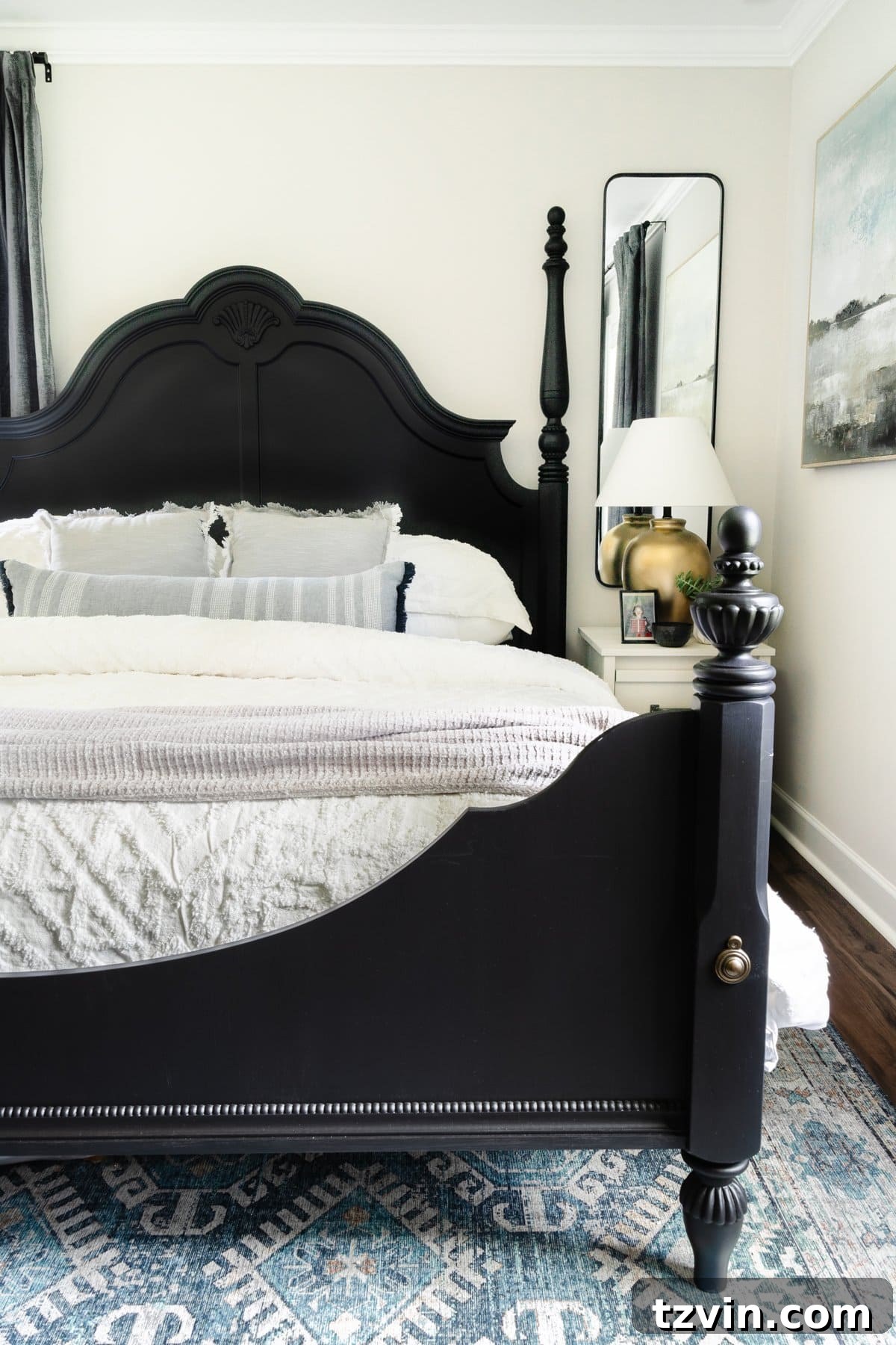 The Enduring Appeal of Classic Interior Design 15 A black poster bed adorned with crisp white bedding, creating a fresh and timeless look in the bedroom.