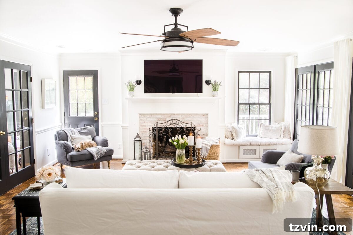 Spring Refresh Living Room Reveal 2 A beautifully refreshed living room featuring a cozy sofa, floral arrangements, natural textures, and warm lighting, perfect for spring decor enthusiasts and home design inspiration.