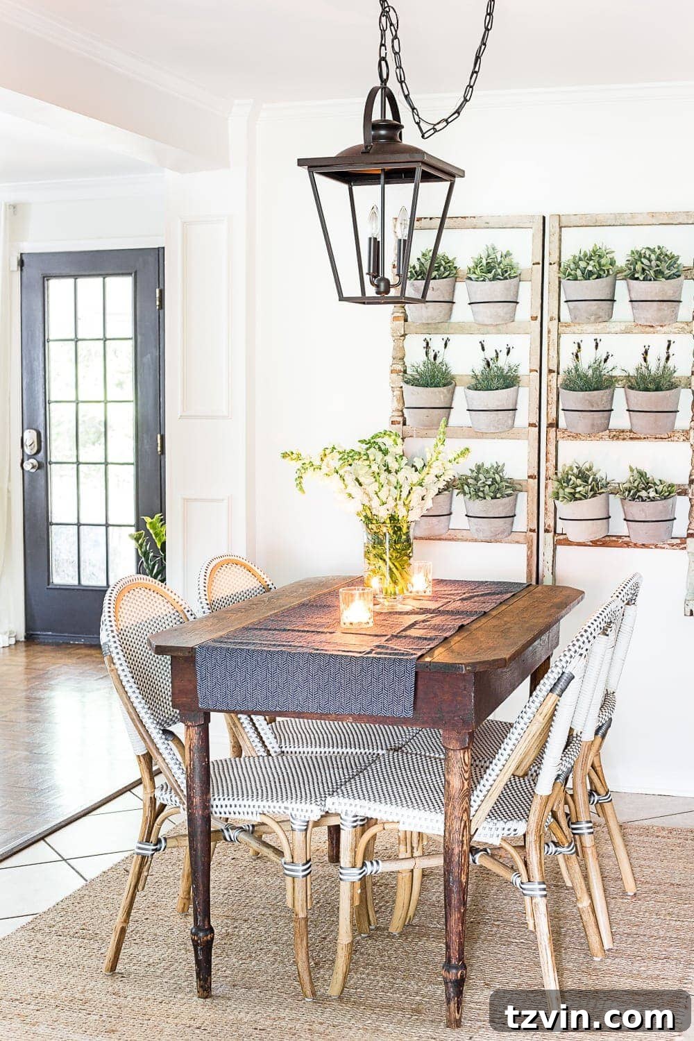 breakfast nook decorated for summer with a DIY wall planter made from antique banisters