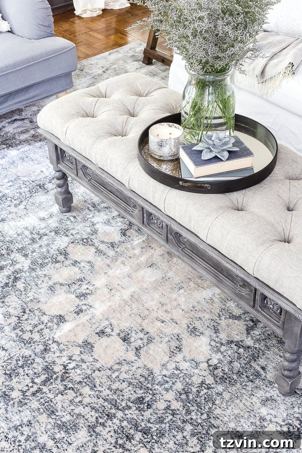 blue gray living room rug with DIY ottoman from a thrifted coffee table