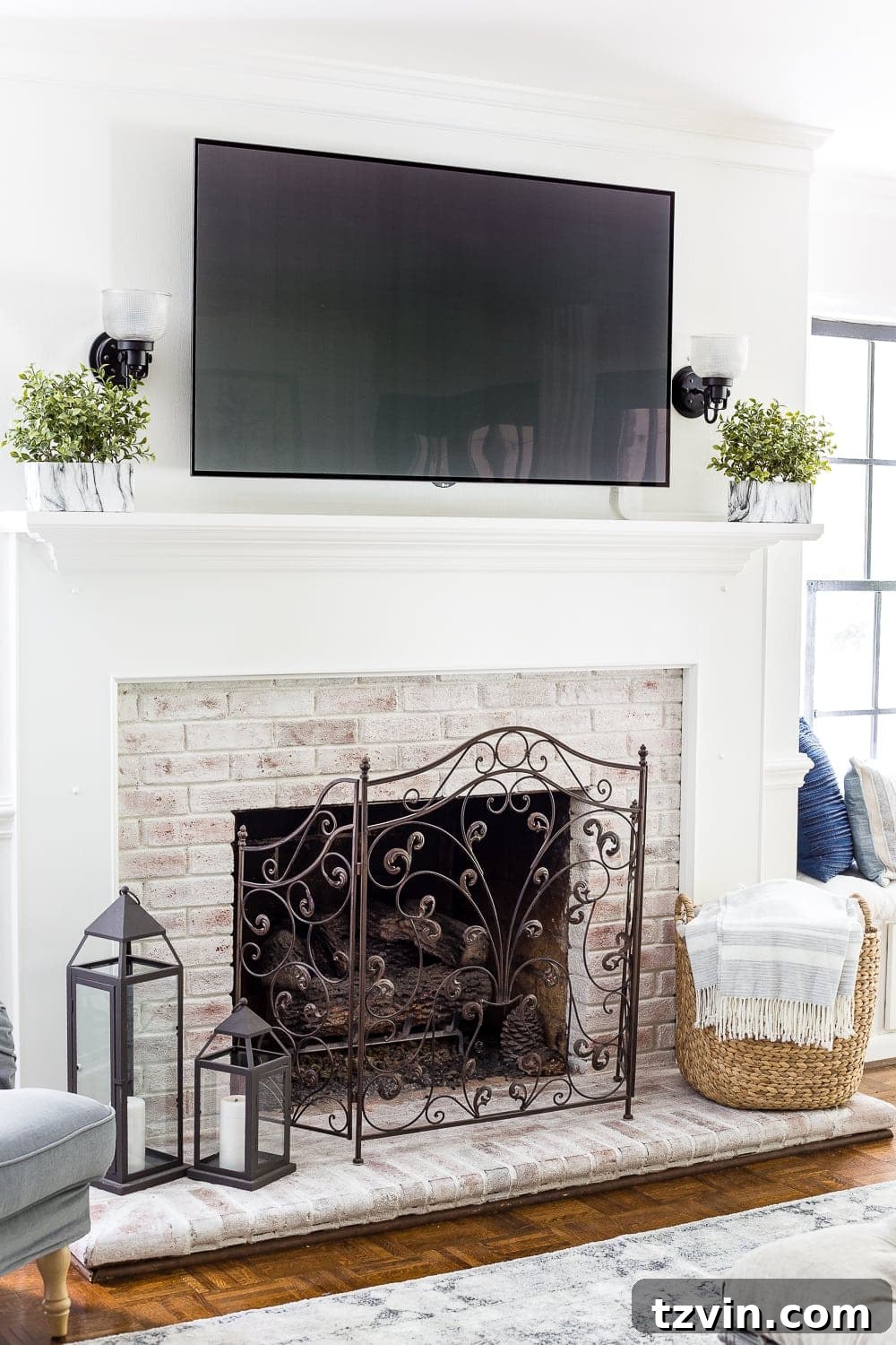 limewashed brick fireplace with tv above mantel