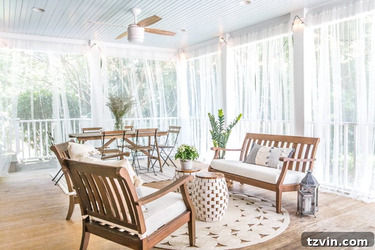 The summer back porch with elegant mosquito net curtains drawn, creating a protected and cozy ambiance.