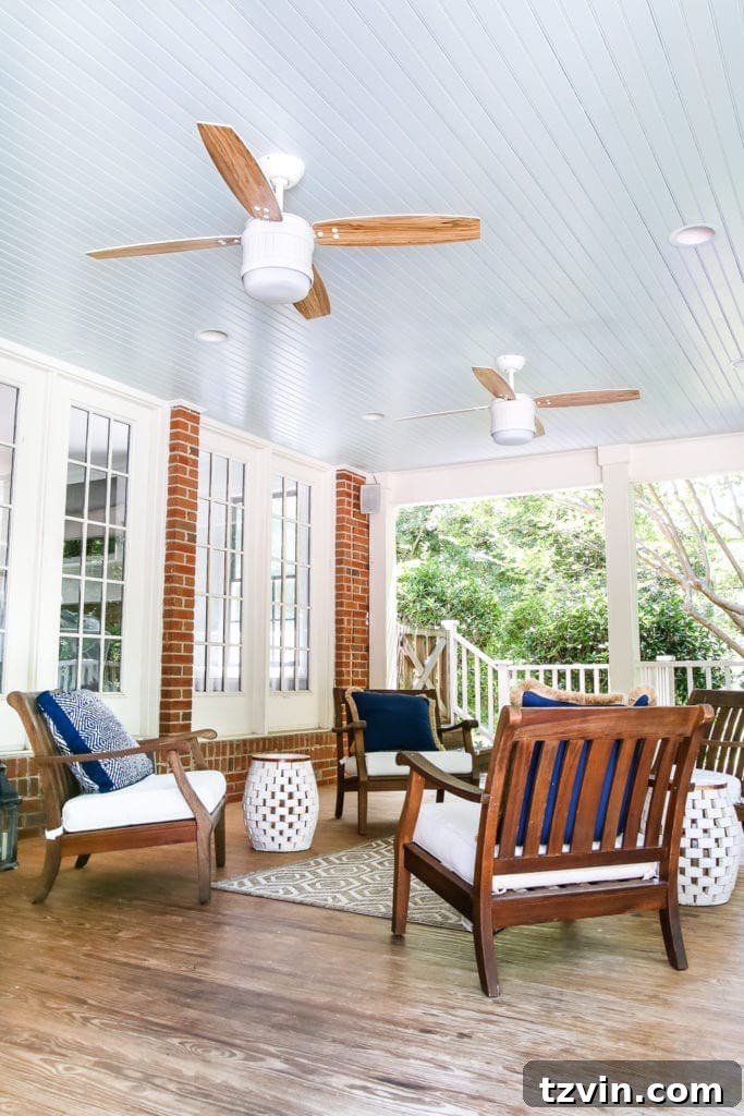 Back porch showcasing the newly painted haint blue ceiling and stylish updated ceiling fans.