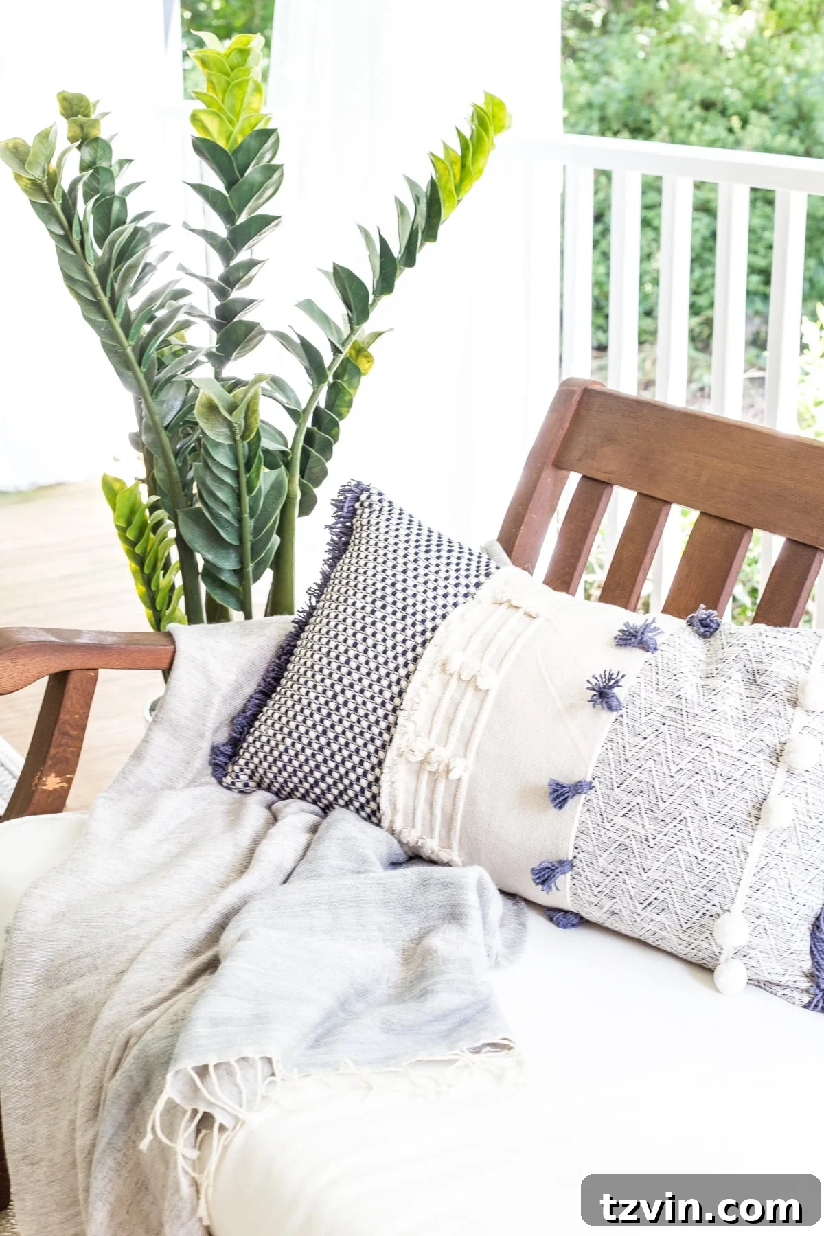 A close-up of summer outdoor decor on the back porch, featuring a vibrant throw pillow adding a pop of color.
