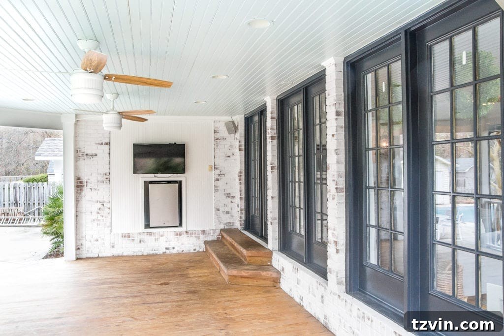 Sub-$100 Porch Paradise: DIY Curtains & Screens 2 Beautiful limewashed brick back porch featuring a haint blue ceiling, showcasing a fresh and inviting outdoor living space.