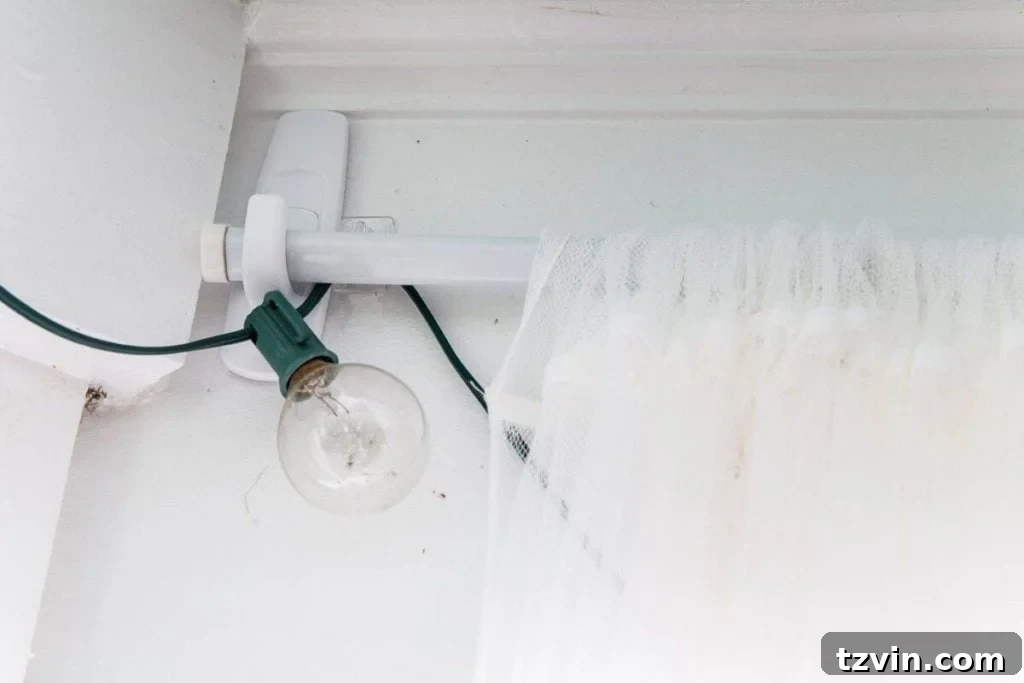 Sub-$100 Porch Paradise: DIY Curtains & Screens 4 Applying Scotchgard Heavy Duty Water Shield to outdoor curtains to waterproof them, essential for protecting fabrics from rain and sun.