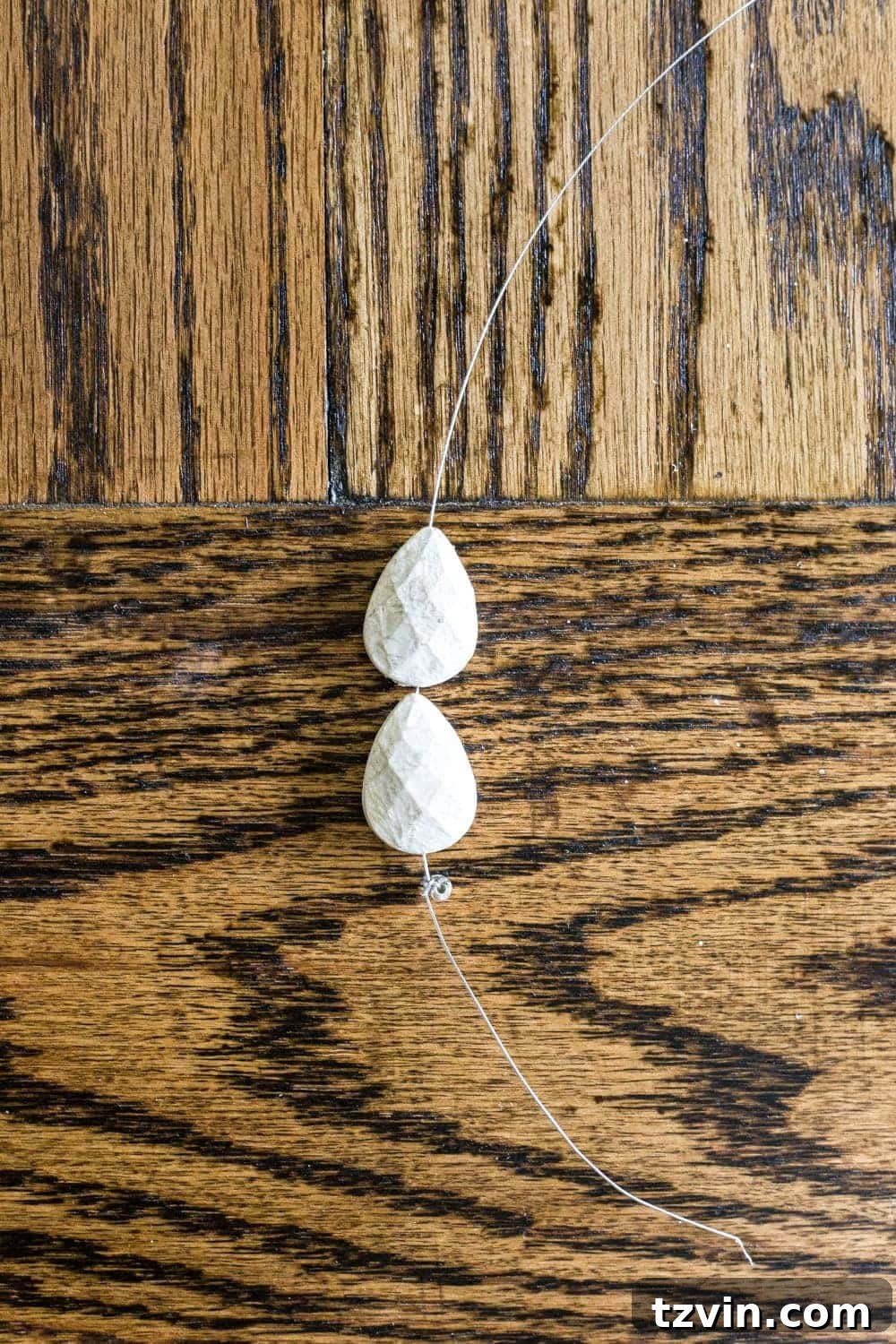 DIY chandelier beads for French sconce being attached