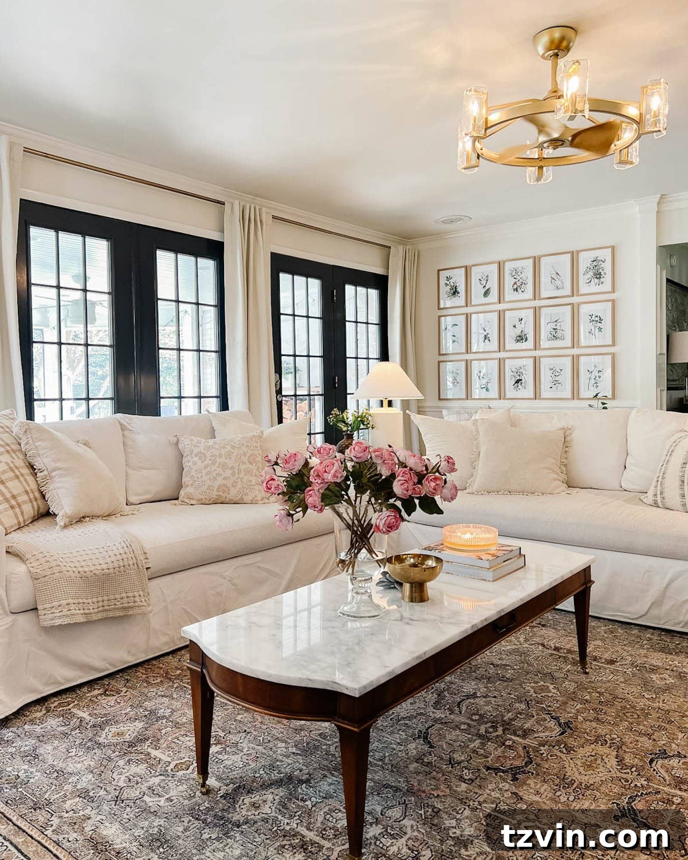 23 Smart Hacks to Make Your Small Room Feel Instantly Bigger 12 living room with white walls, black French doors, and white sofas with a rug and marble topped coffee table