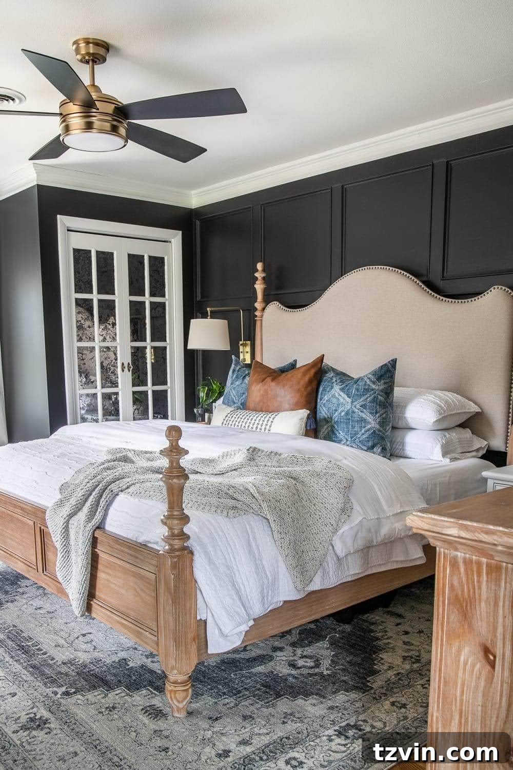23 Smart Hacks to Make Your Small Room Feel Instantly Bigger 14 black bedroom with king sized bed, white mirrored closet doors, and white bedding