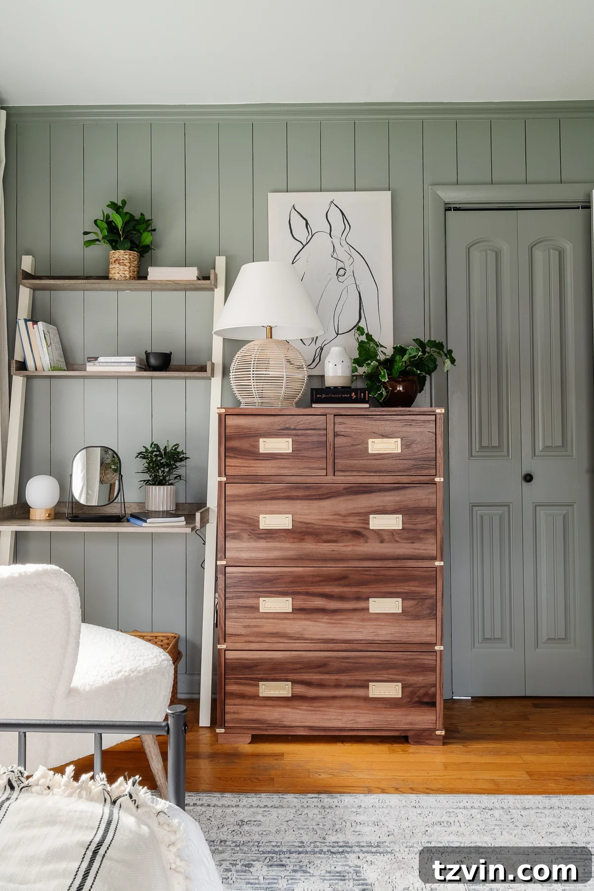 23 Smart Hacks to Make Your Small Room Feel Instantly Bigger 6 sage green bedroom with wood dresser, leaning desk, and white boucle desk chair