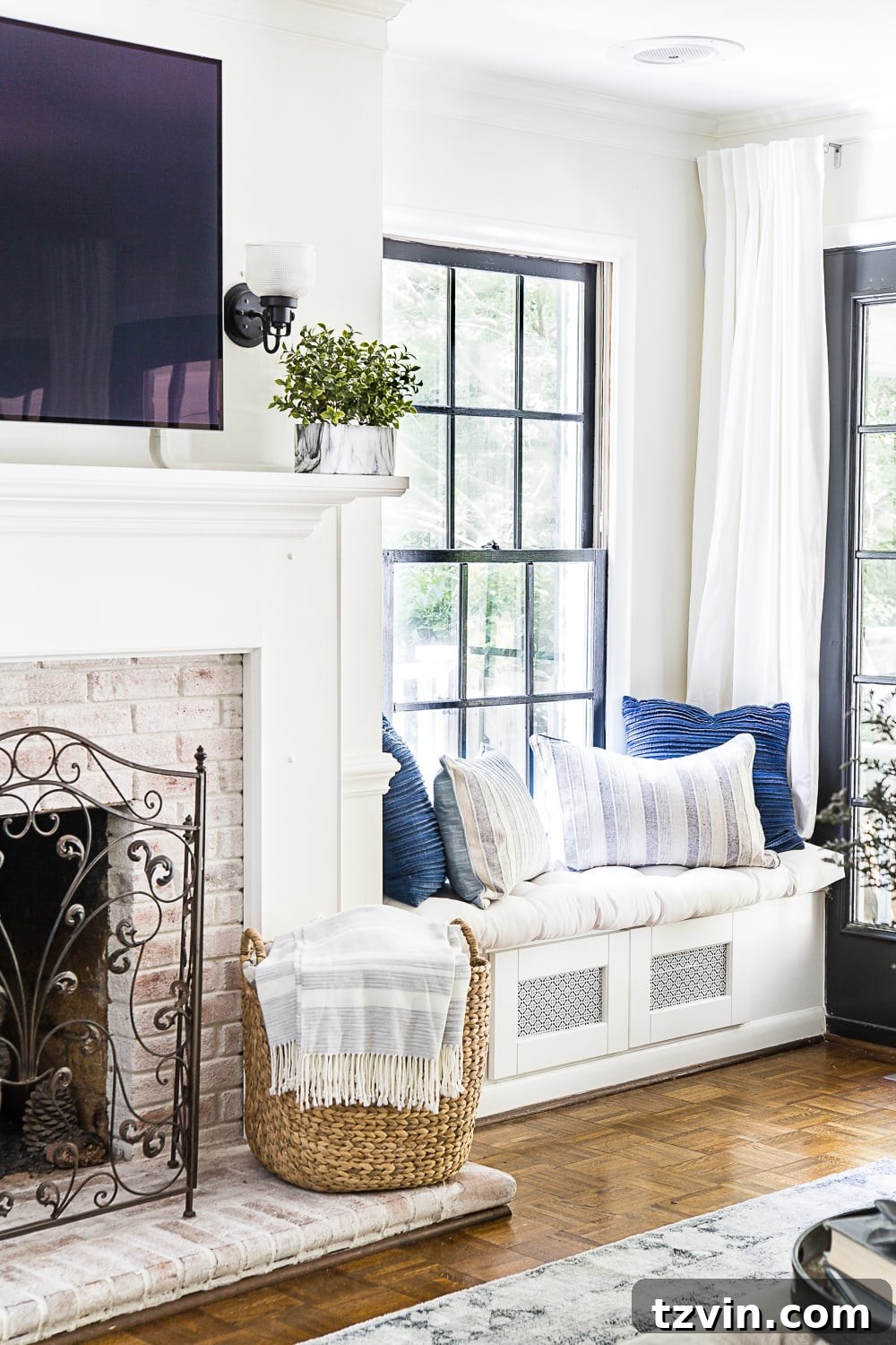 23 Smart Hacks to Make Your Small Room Feel Instantly Bigger 7 living room with window seat for electronics storage and limewashed fireplace