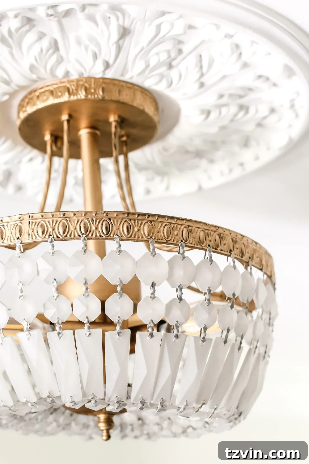 30 Must-Have Home Decor Treasures from Thrift Stores 7 Thrifted light fixture painted with Rub n Buff and frosted glass spray paint, showcasing a successful transformation.