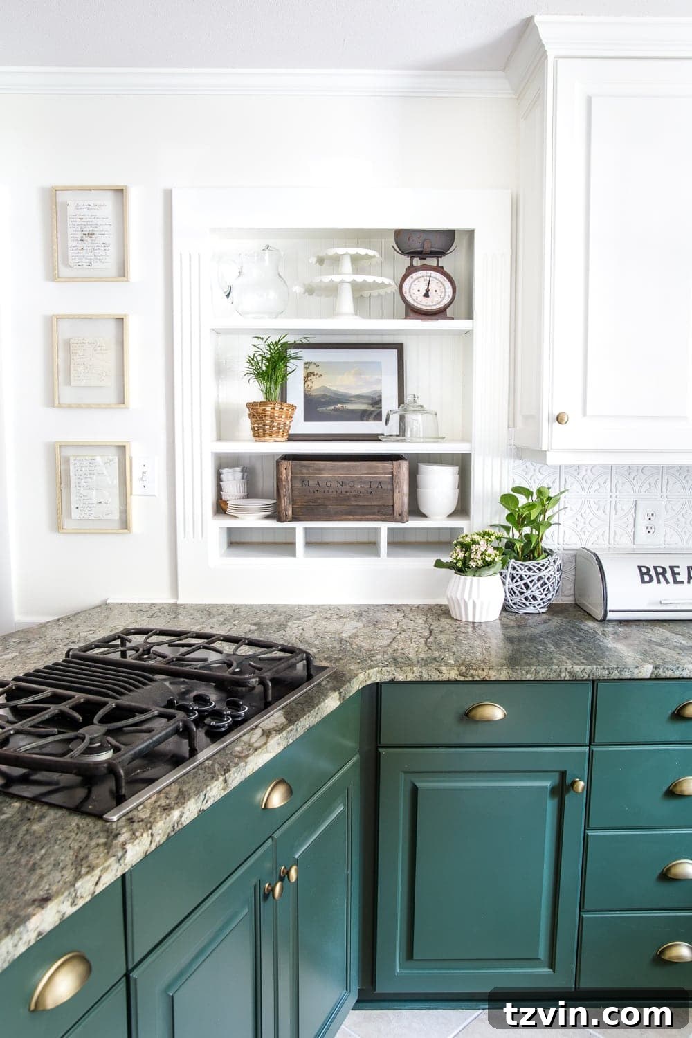 Kitchen shelves with dark green cabinets and framed handwritten recipes for art