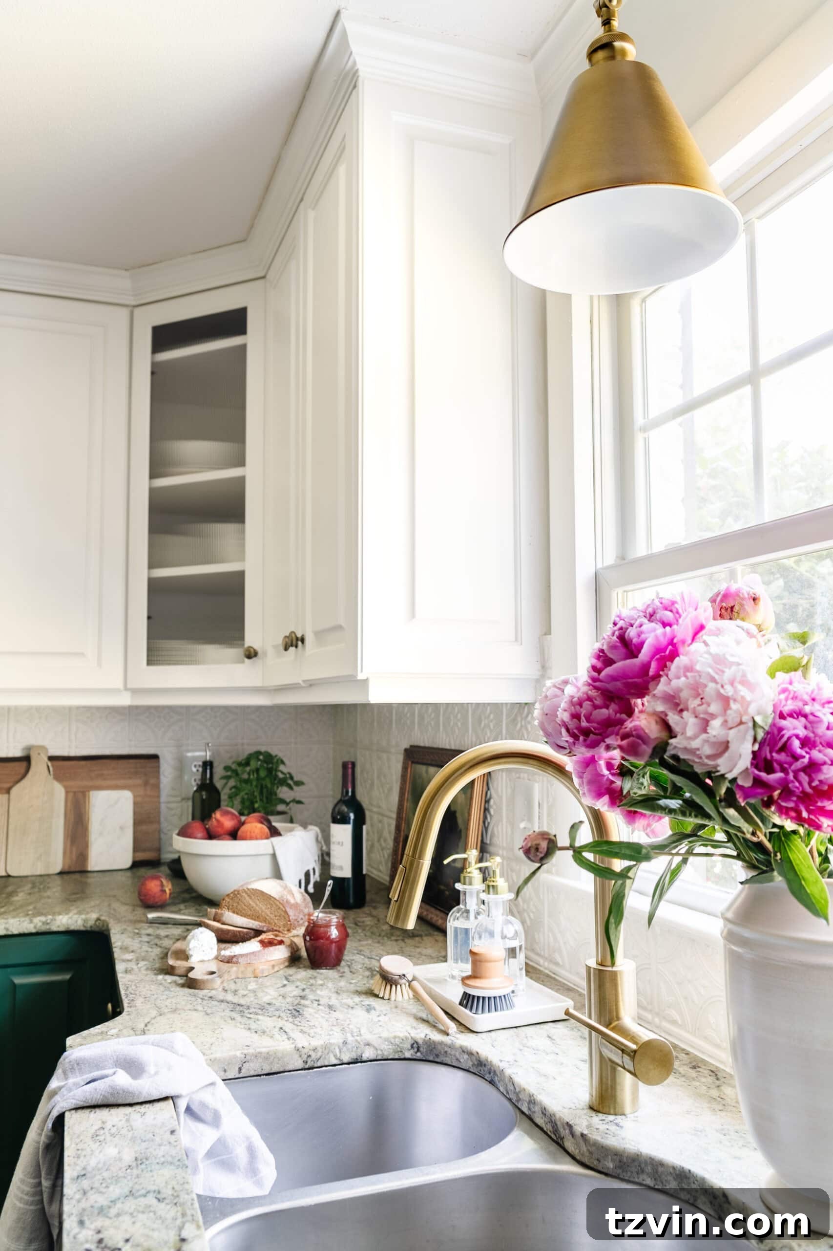 Cozy Cottagecore Kitchen Transformations for Less 12 kitchen sink in front of window with brass faucet and brass pendant light