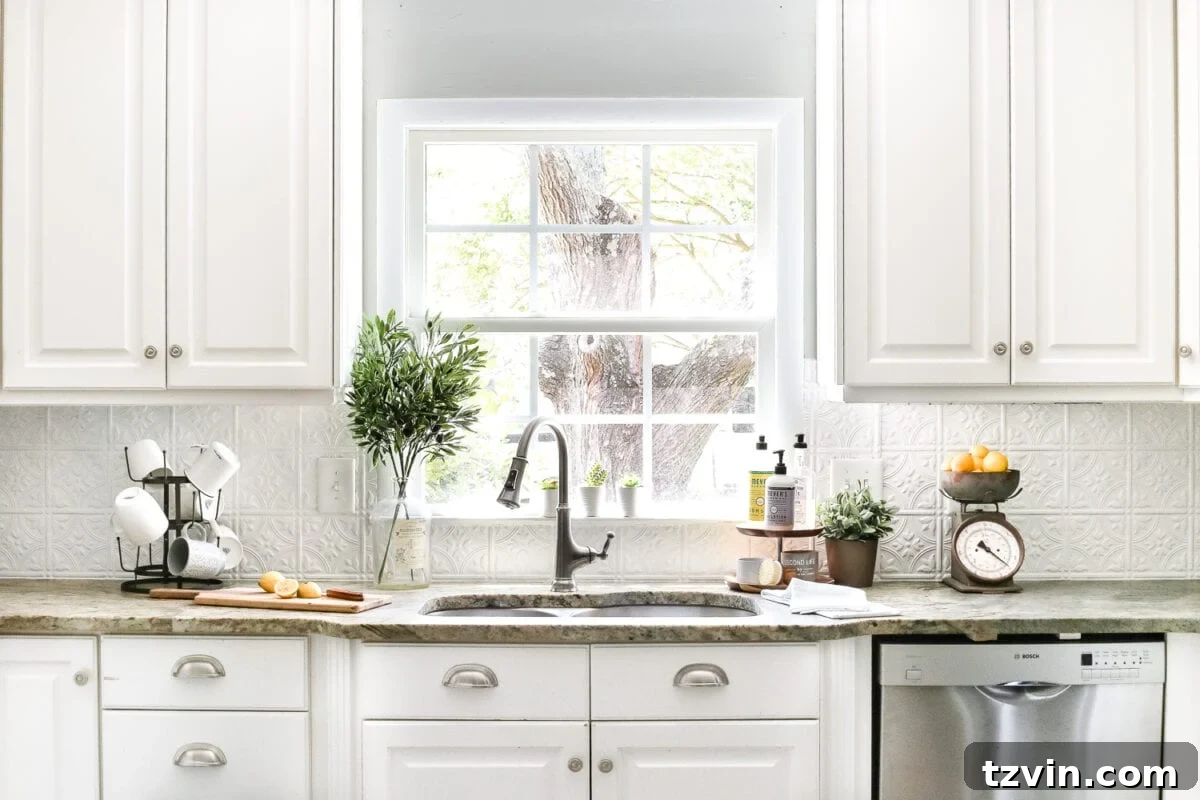 Cozy Cottagecore Kitchen Transformations for Less 21 kitchen with white cabinets and sink in front of window