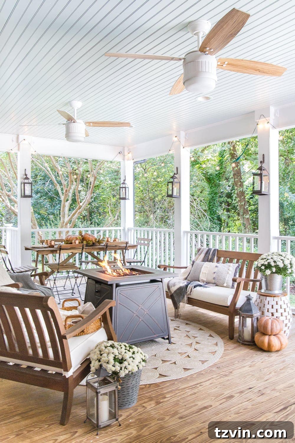 Fall Porch Perfection: Crafting Your Cozy Outdoor Oasis 2 Cozy fall porch with pumpkins, a gas fire pit, lanterns and string lights
