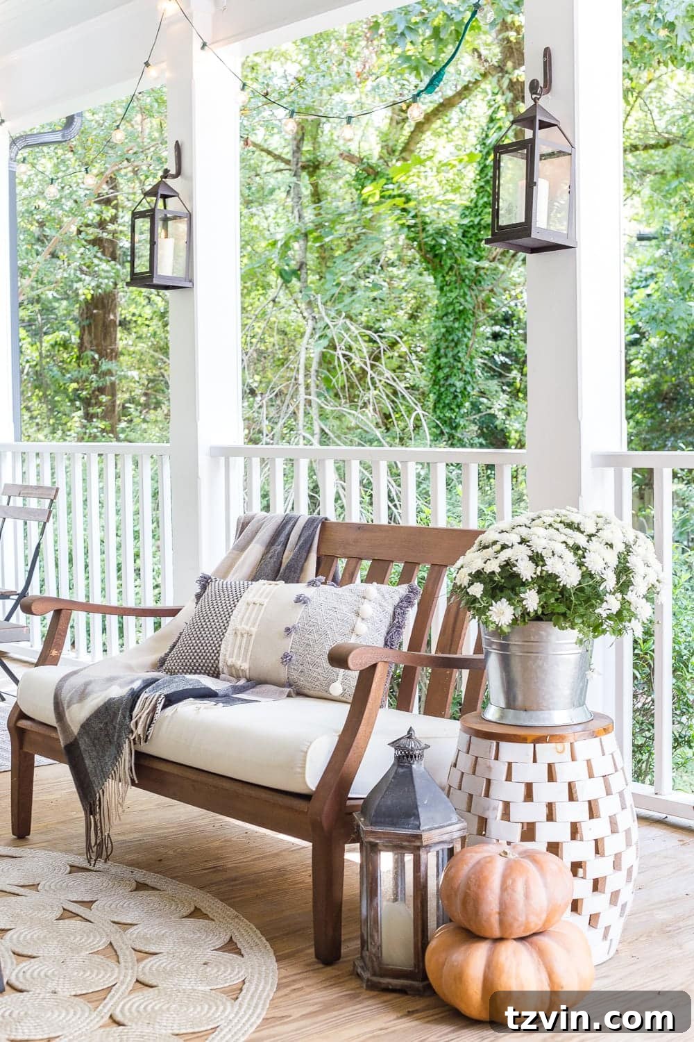 Fall Porch Perfection: Crafting Your Cozy Outdoor Oasis 11 cozy fall porch with plaid throw blankets, textured pillows, pumpkins, lanterns, mums, and string lights
