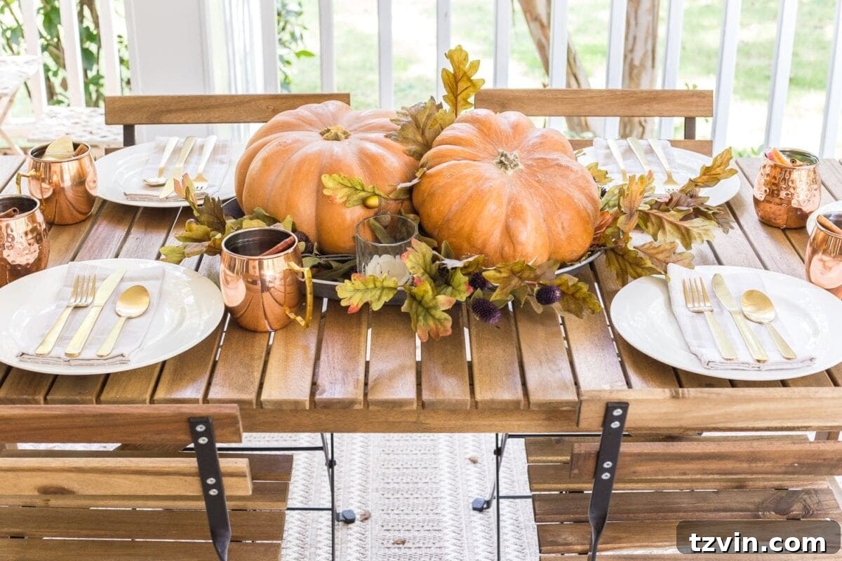 Fall Porch Perfection: Crafting Your Cozy Outdoor Oasis 14 cozy fall porch with outdoor dining and simple pumpkin centerpiece
