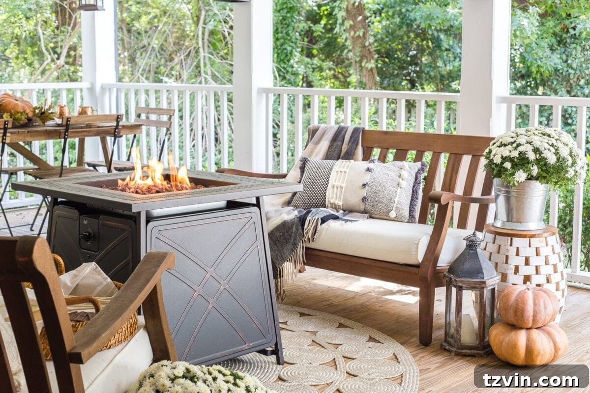 Fall Porch Perfection: Crafting Your Cozy Outdoor Oasis 3 Cozy fall porch with gas fire pit, pumpkins, and mums