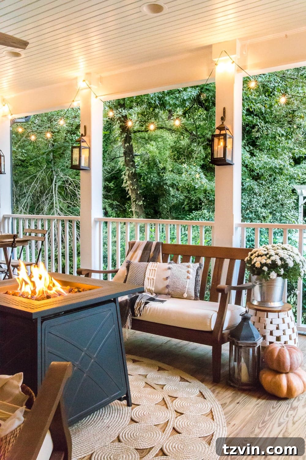Fall Porch Perfection: Crafting Your Cozy Outdoor Oasis 19 cozy fall porch with fire pit, string lights, and lanterns
