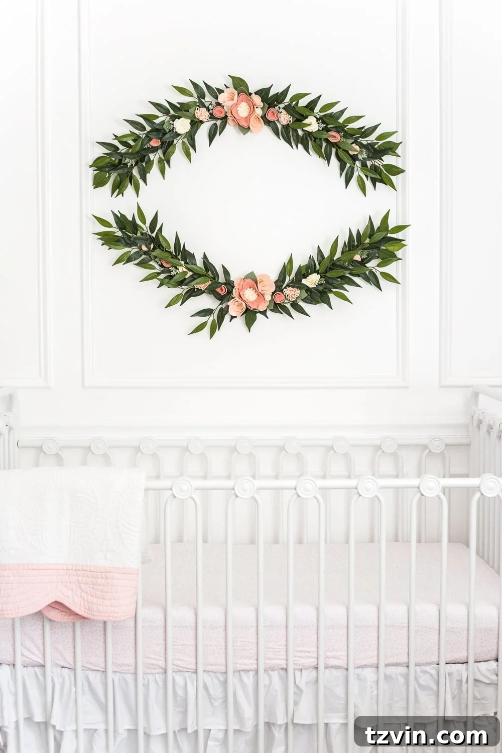 Blossoming Dreams: White Floral Nursery Reveal 12 Close-up of the felt flower swag garland in the white nursery.