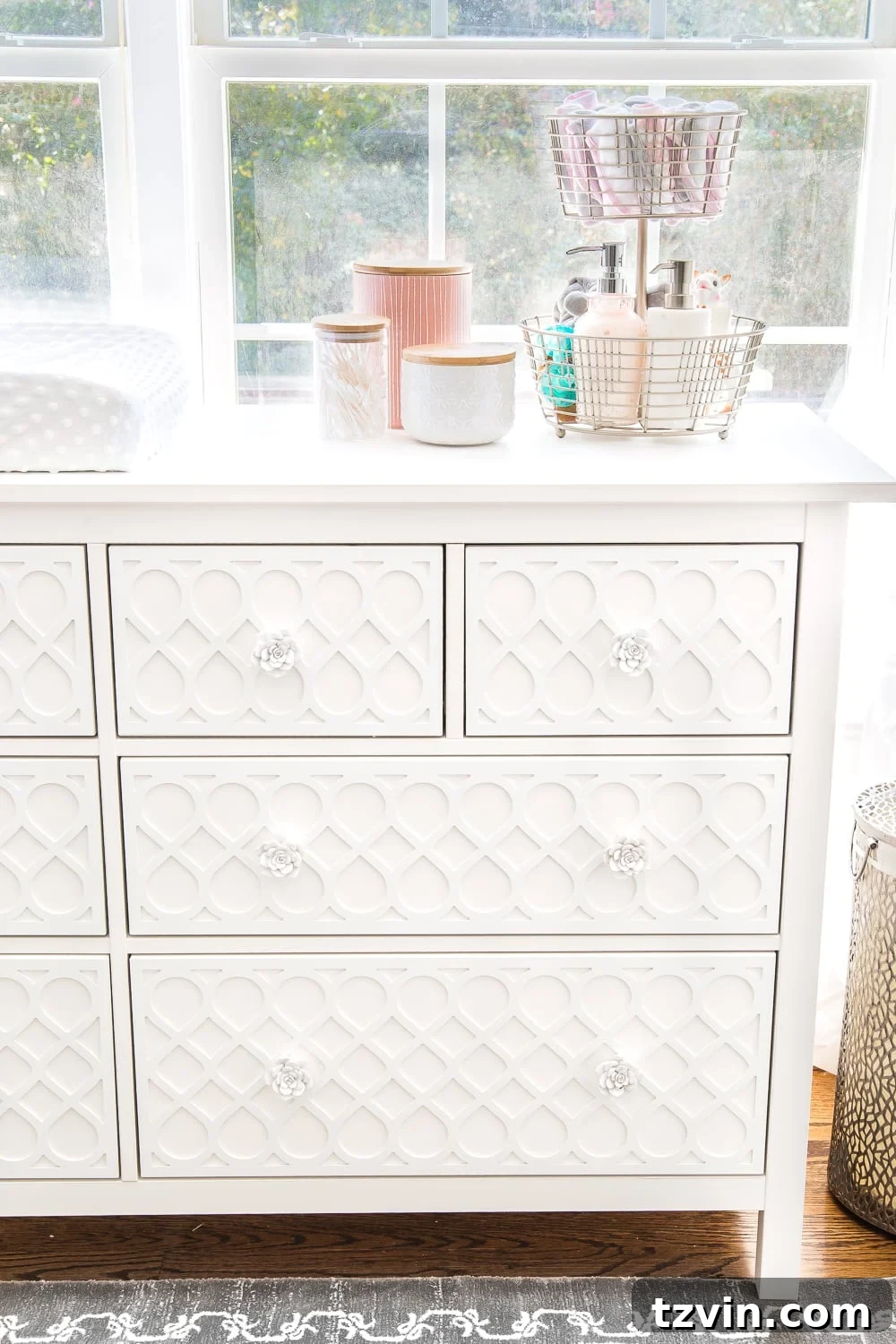 Blossoming Dreams: White Floral Nursery Reveal 22 Glass and ceramic canisters for baby essentials in the white nursery.