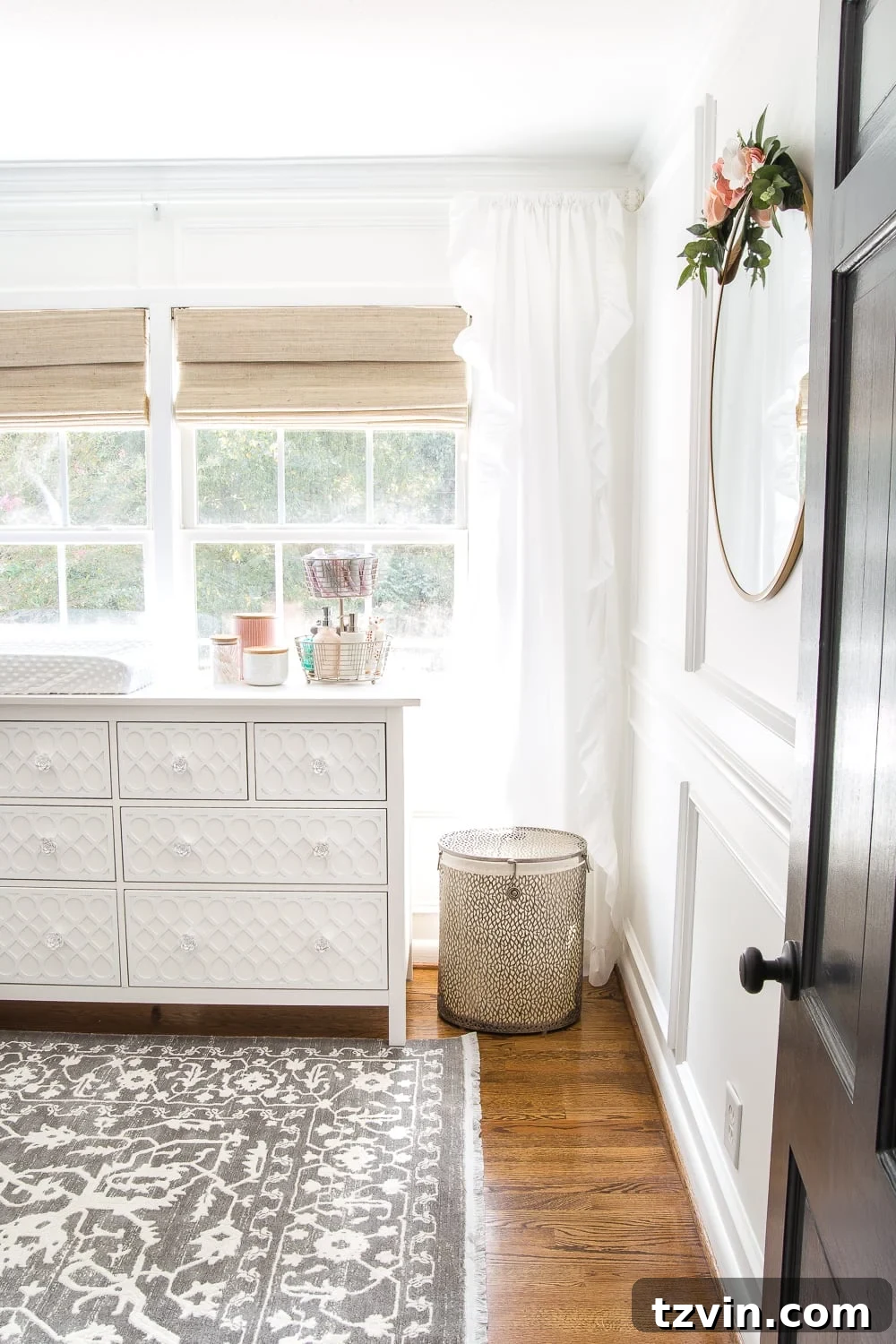 Blossoming Dreams: White Floral Nursery Reveal 5 After photo of the white nursery with a new pendant light and picture frame molding.