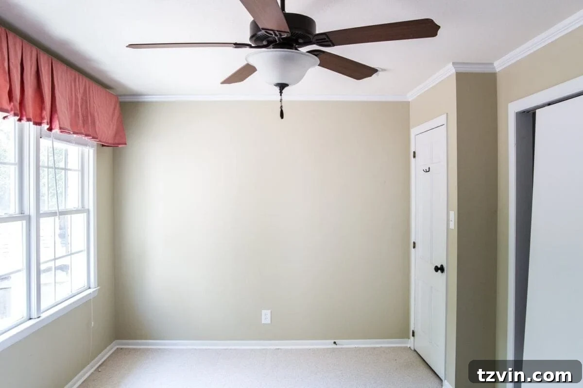 Blossoming Dreams: White Floral Nursery Reveal 6 Nursery before showing an old ceiling fan.