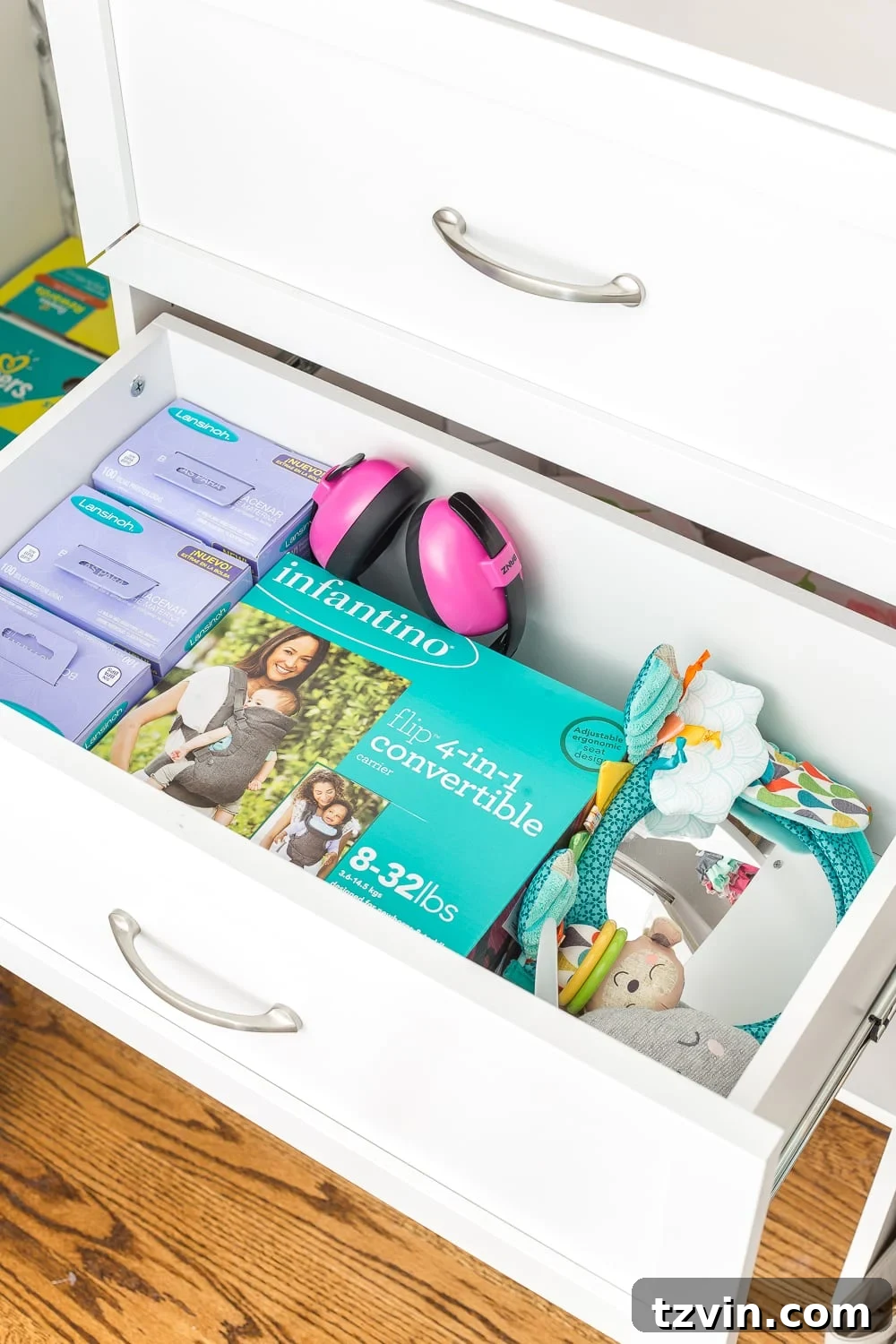 Nursery Organization Secrets Revealed 21 Nursery Organization | Nursery closet drawers with carrier, extra milk storage bags, and tummy time toys.