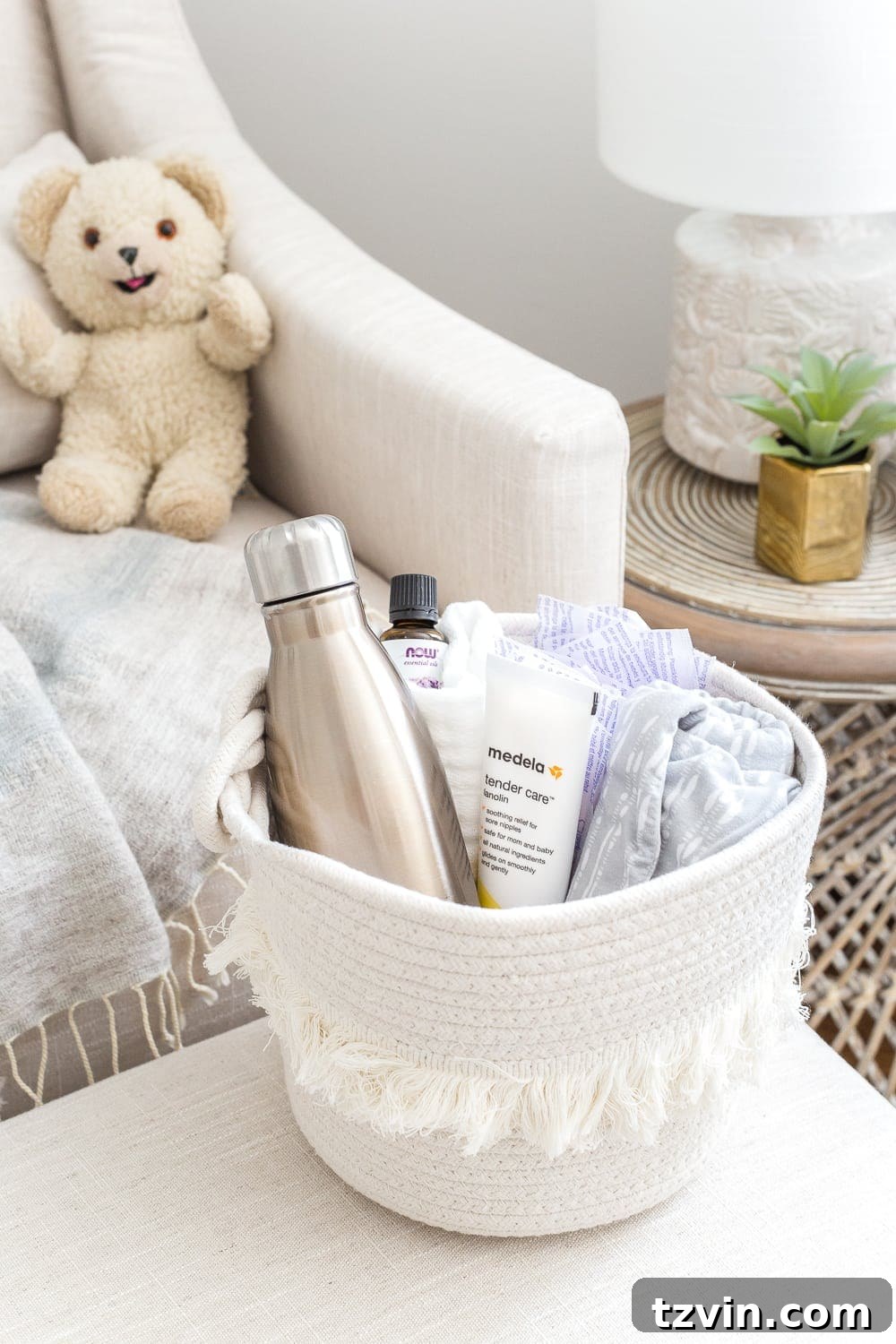 Nursery Organization Secrets Revealed 25 Nursery Organization | Breastfeeding basket to keep beside a chair filled with nursing pads, water bottle, lanolin, burp cloths, nursing cover, and lavender essential oil.